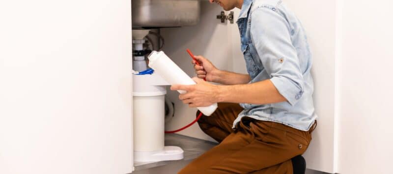 technician installing a water heater inside pflugerville home