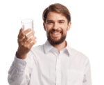man smiling while holding a glass water