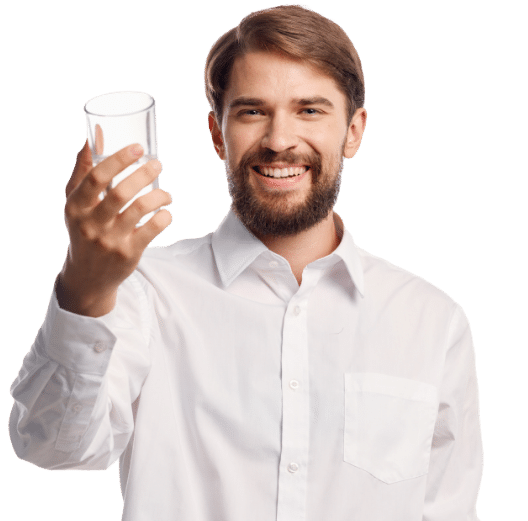 man smiling while holding a glass water